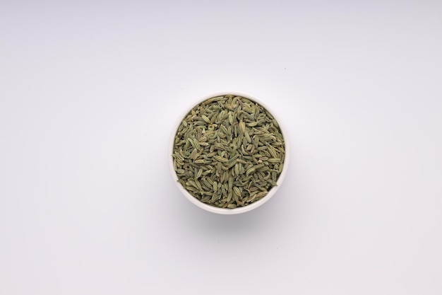 Fennel seed indian spicearranged in a white bowl  with white colored background