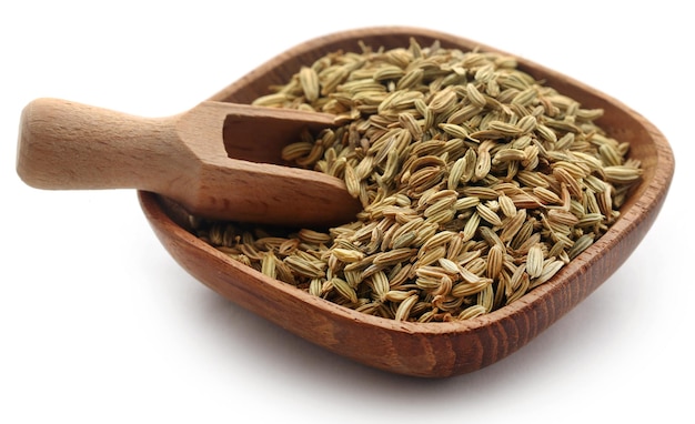 Fennel seeds in bowl over white background