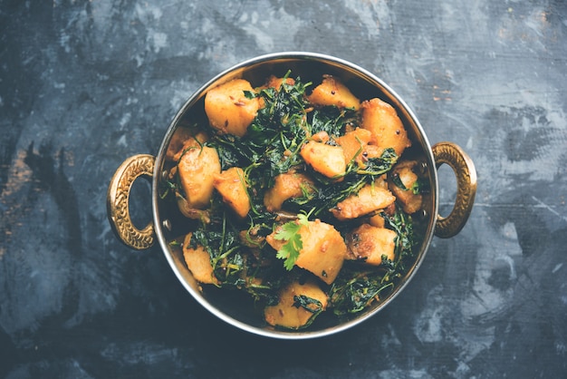 Fenugreek potato sabzi or Aloo Methi masala is healthy Indian Cuisine. served in a bowl or karahi. selective focus