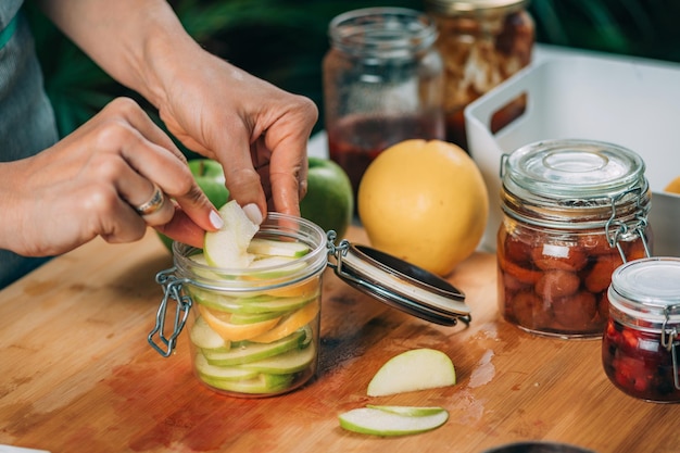 Foto cibi a fermentazione a casa donna che prepara frutta per la fermentazione