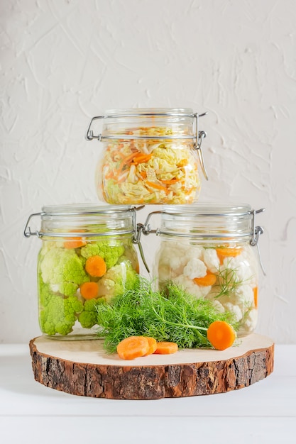 Fermented preserved probiotic vegetarian food: cabbage, broccoli, sauerkraut in glass jars 