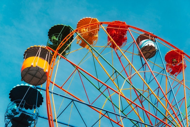 Ferris wheel against clear blue sky in amusement park