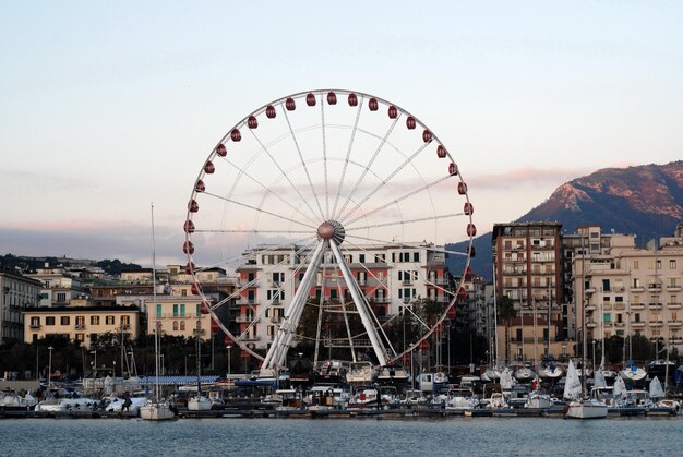 Ferris wheel at amusement park against sky