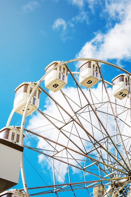 Ferris wheel on the background of blue sky 