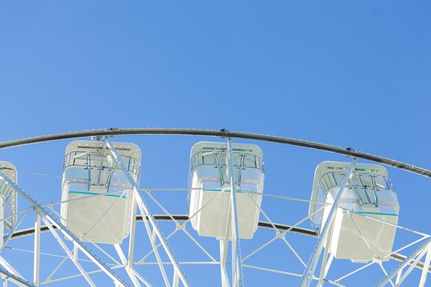 Ferris wheel on the blue sky background