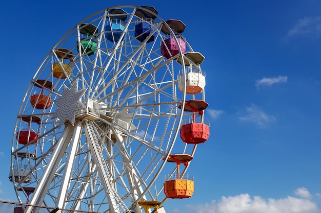 Ferris wheel over blue sky