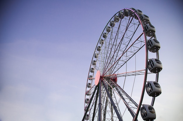 Ferris wheel illuminated against a dark sky in the evening. amusement Park. leisure activities