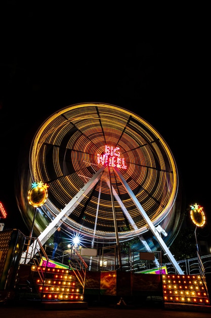 Ferris wheel long exposure shot in the nightVertical format