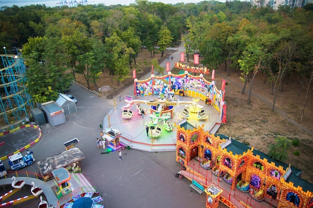 Ferris wheel and rollercoaster in motion at amusement park