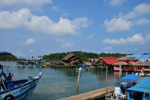 Ferry boat ship stop for send receive thai people foreign travelers and classic modern vintage building of resort hotel at seaside beach at Koh Chang island in Gulf on May 28 2011 in Trat Thailand