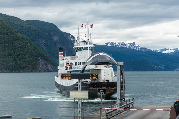 Ferry at the pier in a fjord of Alessund