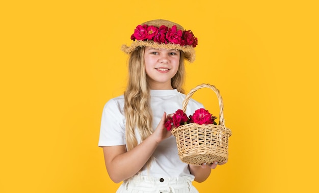 Fertile present female beauty and fashion childhood happiness happy kid with floral decor in headwear child in spring hat small girl with summer rose in hat summer holiday and vacation