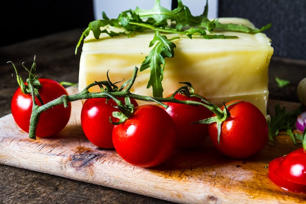 Fesh cheese with tomatoes on the table. 