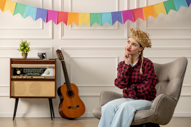 Festa junina cute girl in straw hat brazilian midsummer with retro radio guitar thinking