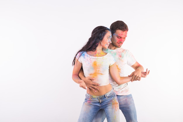 Festival of holi, social dance, friendship - young people playing with colors at the festival of holi festival