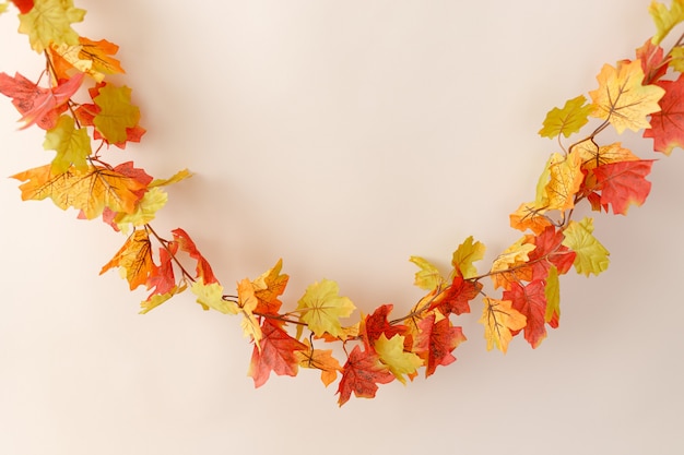 Festive autumn decor with leaves on a beige background Concept of Thanksgiving or Halloween