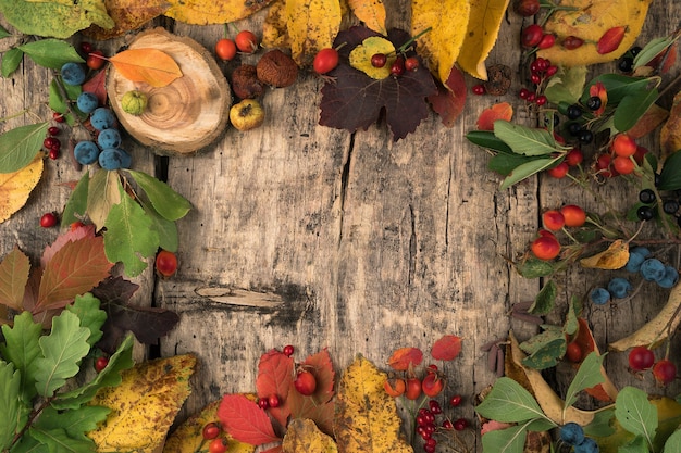 Festive autumn mockup of berries and leaves on a natural wooden table.