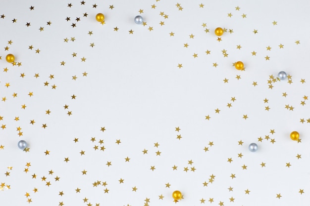 Festive background: confetti gold stars. Free space for text