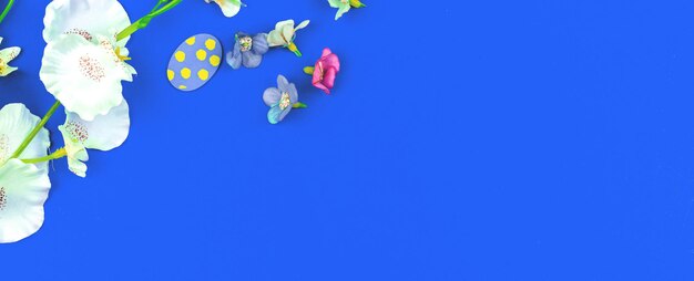 Festive background for easter with painted eggs and spring flowers, banner and copy space composition photo