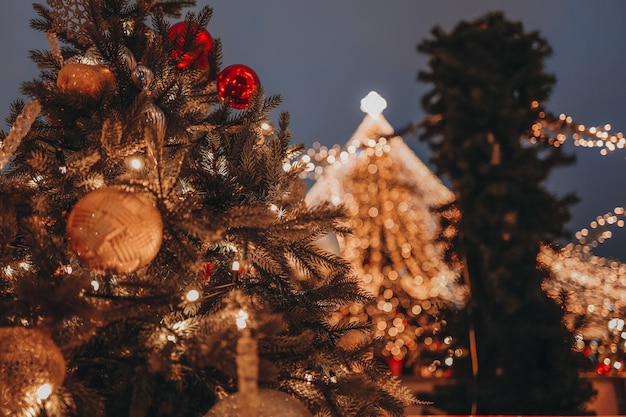 Festive background with beautiful Golden bokeh lights Christmas ball golden fir branches