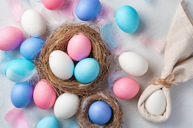 Festive background with Easter eggs and a rabbit on a gray background Top view Happy Easter