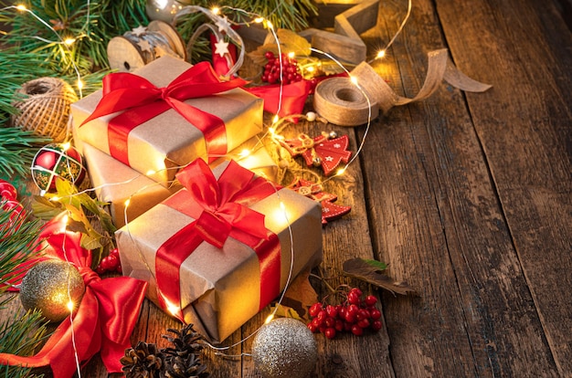 Festive background with gifts and Christmas tree toys on a wooden table