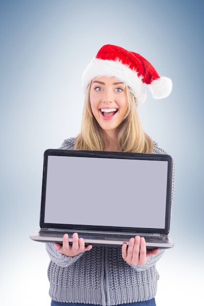 Festive blonde holding a laptop