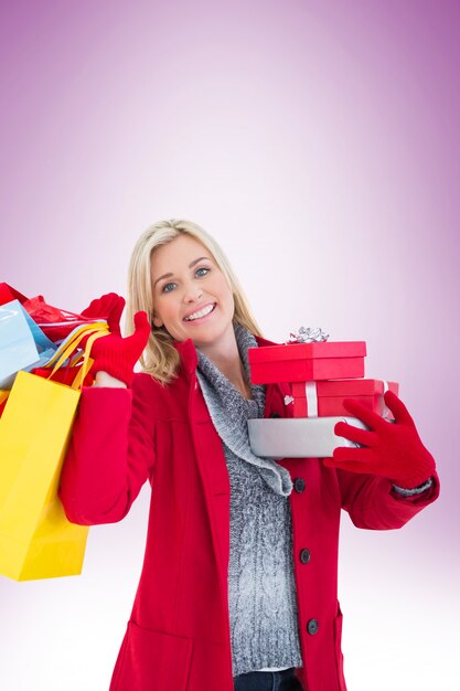 Festive blonde holding many gifts