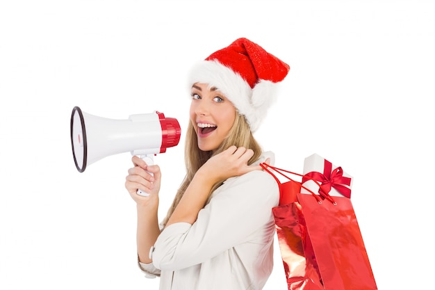 Festive blonde holding megaphone and bags