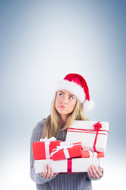 Festive blonde holding pile of gifts