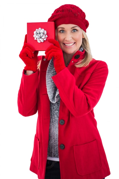 Festive blonde holding red gift 