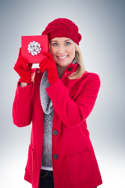 Festive blonde holding red gift 