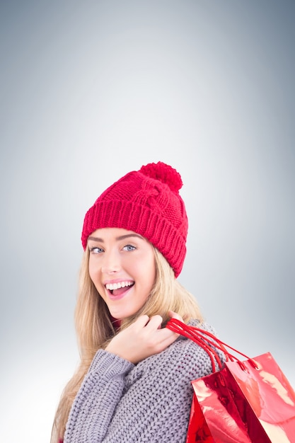 Festive blonde holding shopping bags