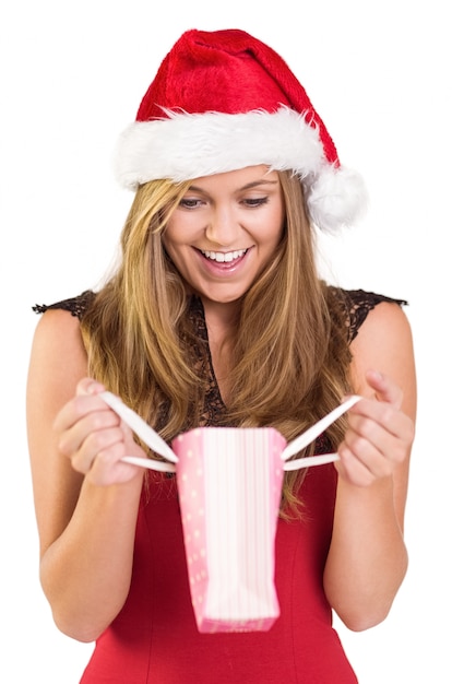 Festive blonde opening a gift bag