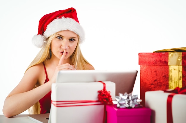 Festive blonde shopping online with laptop