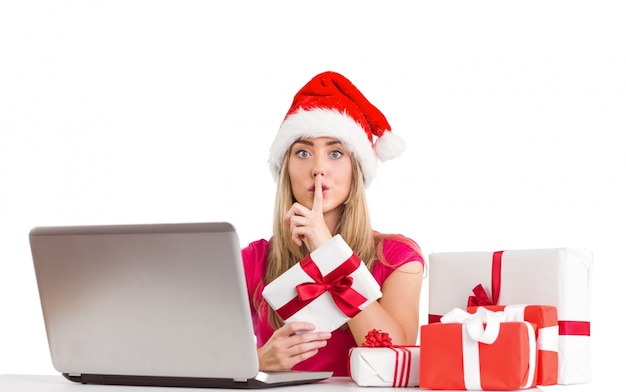 Festive blonde shopping online with laptop