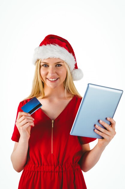 Festive blonde shopping online with tablet