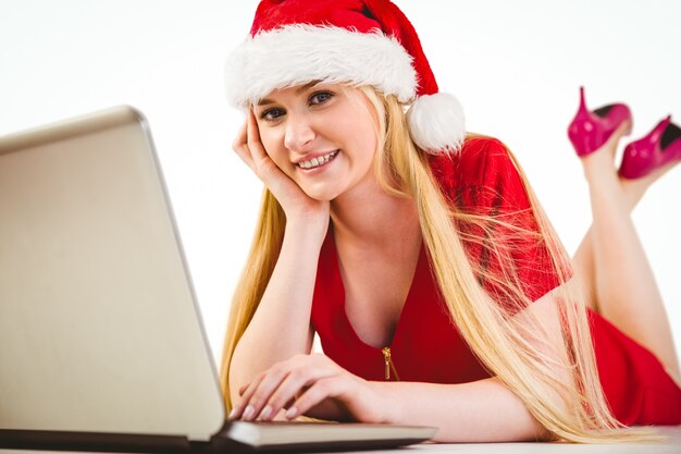 Festive blonde using a laptop