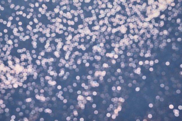 Photo festive blue background of silver glitter lights winter blurred abstraction