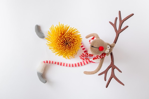 Festive bouquet of raw spaghetti with a toy deer View from above