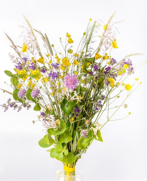 Festive bouquet of yellow and purple wildflowers herbs on a white background Birthday Mothers Valentines Womens Wedding Day concept