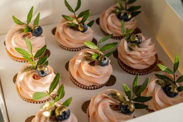 Festive box of pink cupcakes.