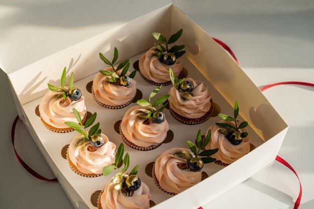 Festive box of pink cupcakes.