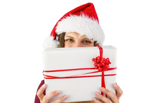 Festive brunette holding christmas present with bow