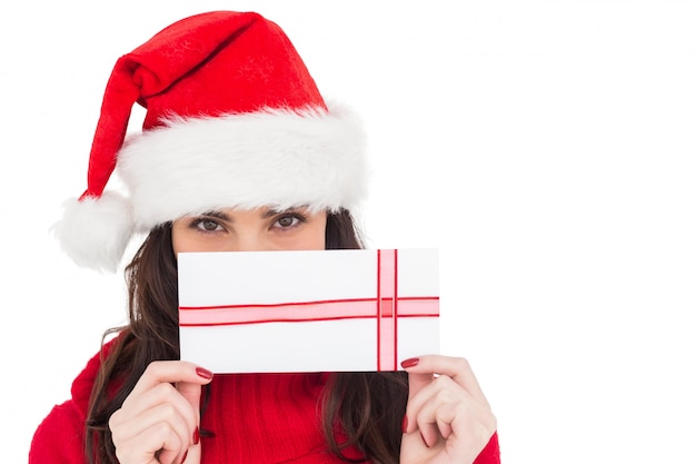 Festive brunette holding a gift