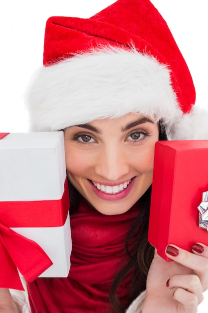 Festive brunette showing christmas gifts