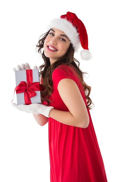 Festive brunette showing gift 