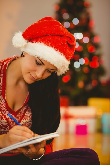 Festive brunette writing her list