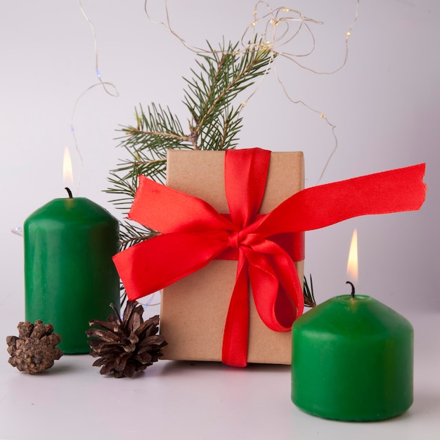 Festive burning green candles with fir branches