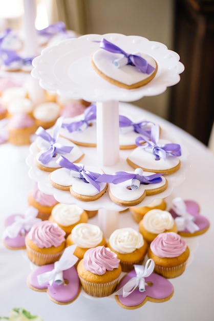 Festive candy bar. Heart shaped cupcakes and gingerbread lie on a plate